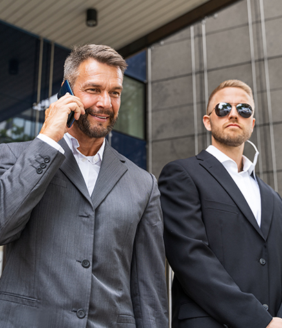 A Men in Suits Stand Outside a Modern Building